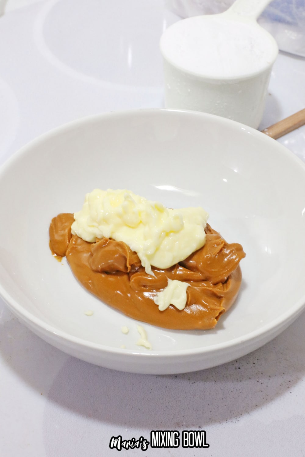 peanut butter and butter in a white mixing bowl