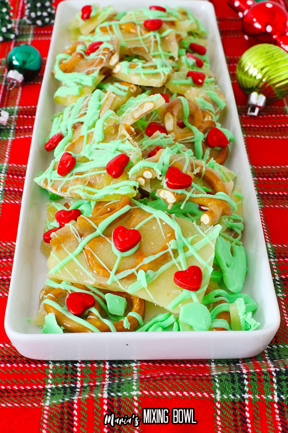 grinch pretzel brittle on a white platter