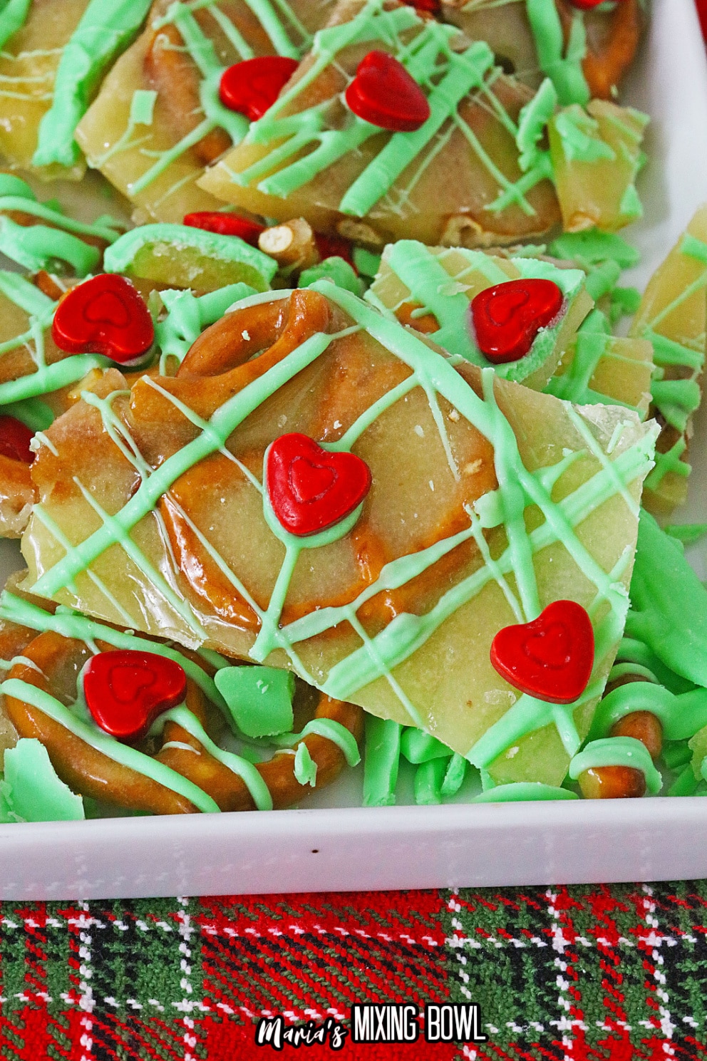 close up image of a piece of grinch pretzel brittle on a white platter