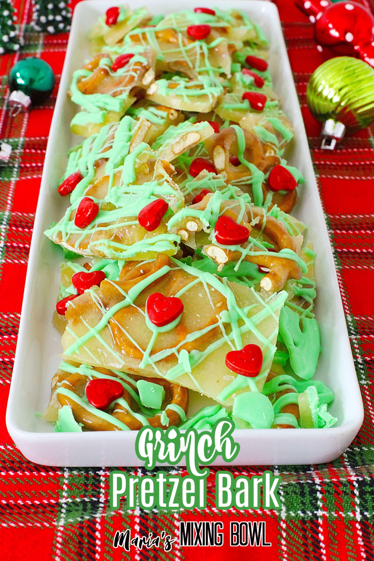 grinch pretzel brittle on a white platter with the name in text for pinterest
