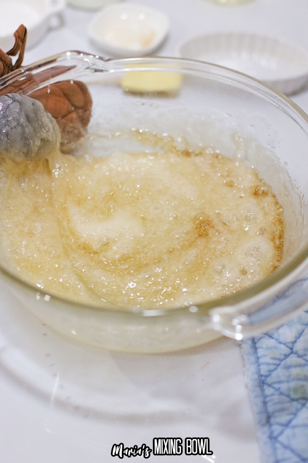 sugar and butter being melted in a glass bowl