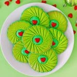 grinch thumbprint cookies on a white plate