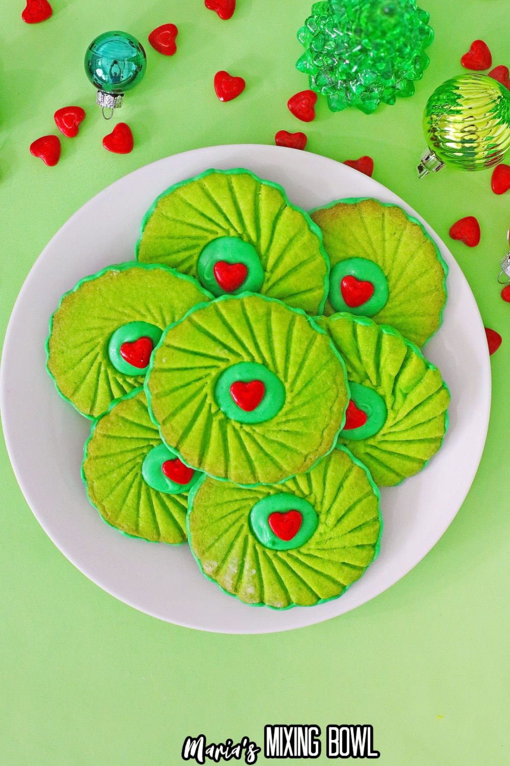 grinch thumbprint cookies on a white plate