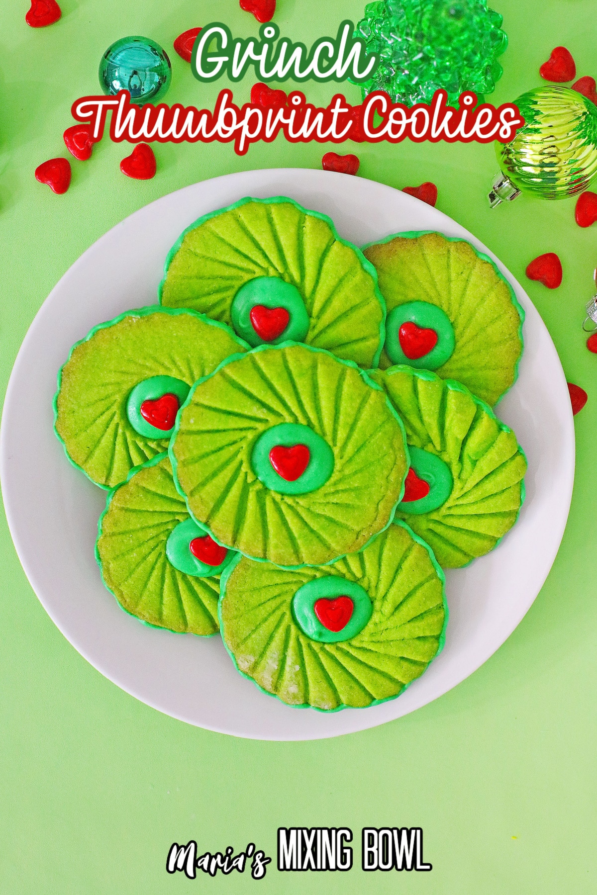 birds eye image of grinch thumbprint cookies with the next in text for pinterest