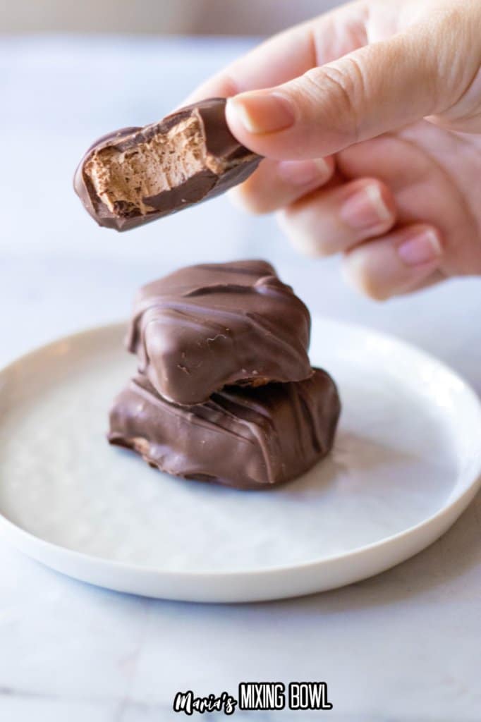 homemade 3 musketeers held in a womans fingers