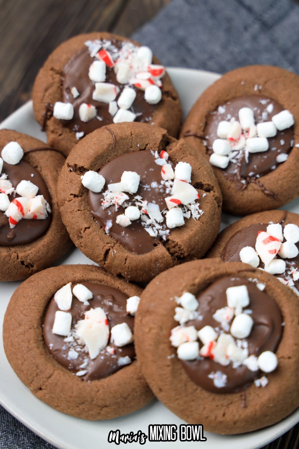 stack of hot cocoa thumbprint cookies on a white plate