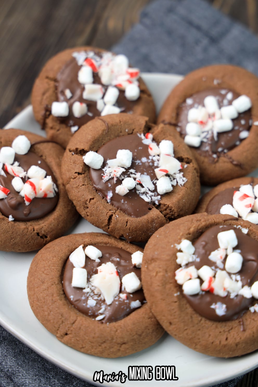 stack of hot cocoa thumbprint cookies on a white plate