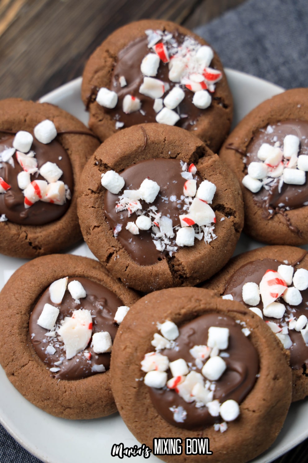stack of hot cocoa thumbprint cookies on a white plate