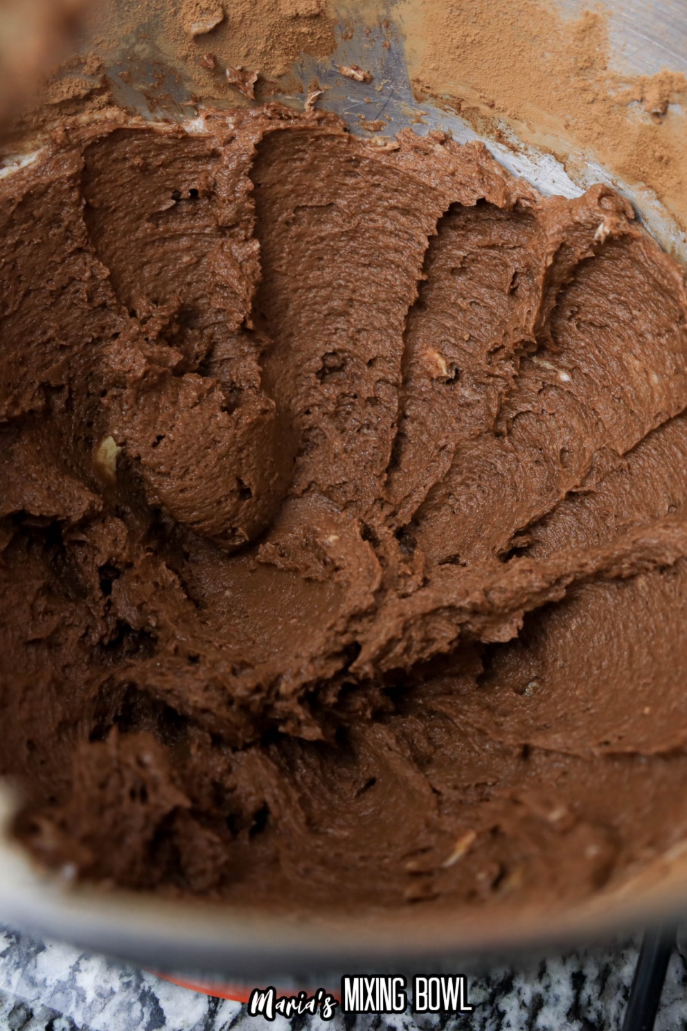 cookie dough in a stainless steel mixing bowl