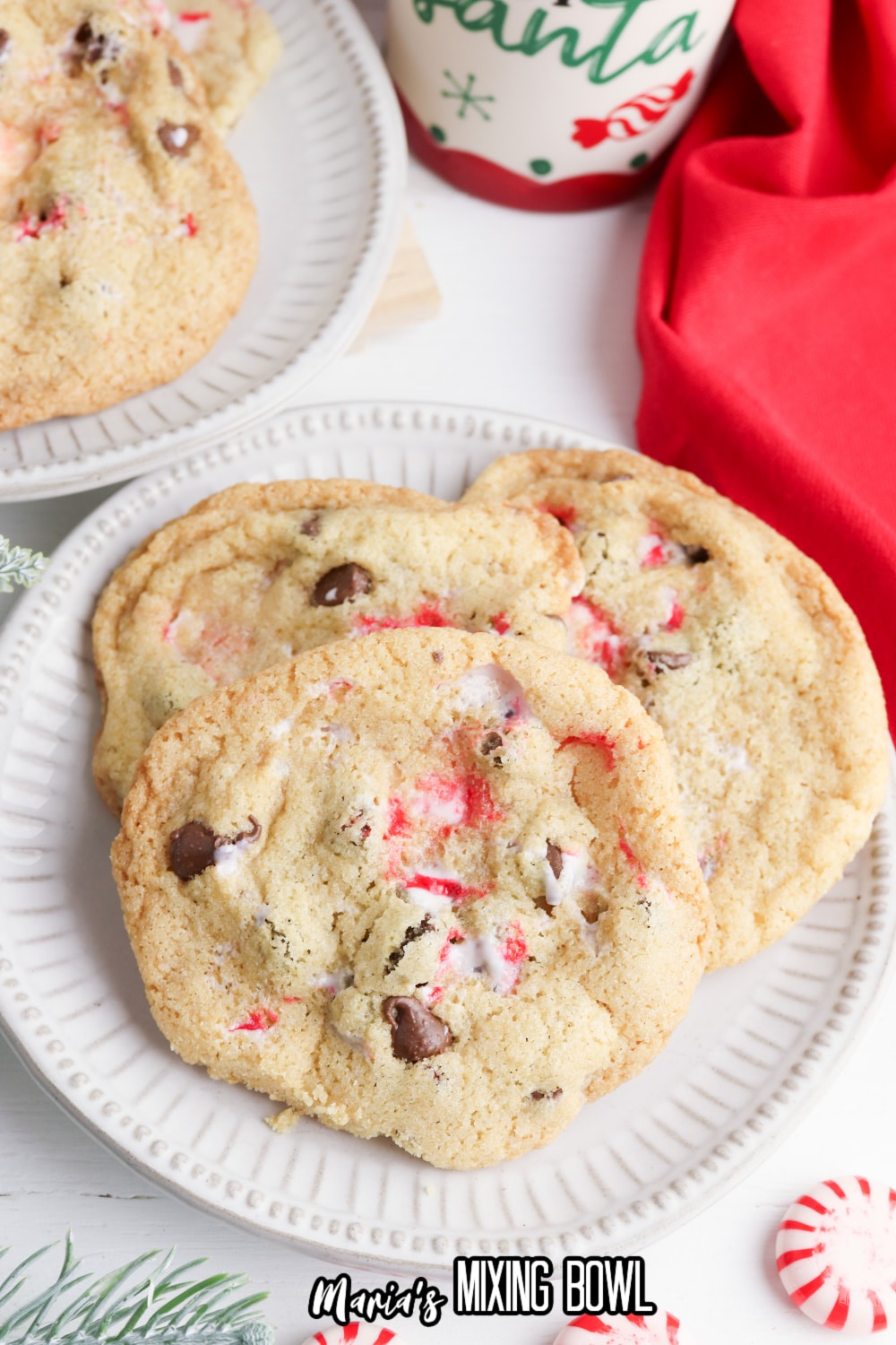 three peppermint chocolate chip cookies on a white plate
