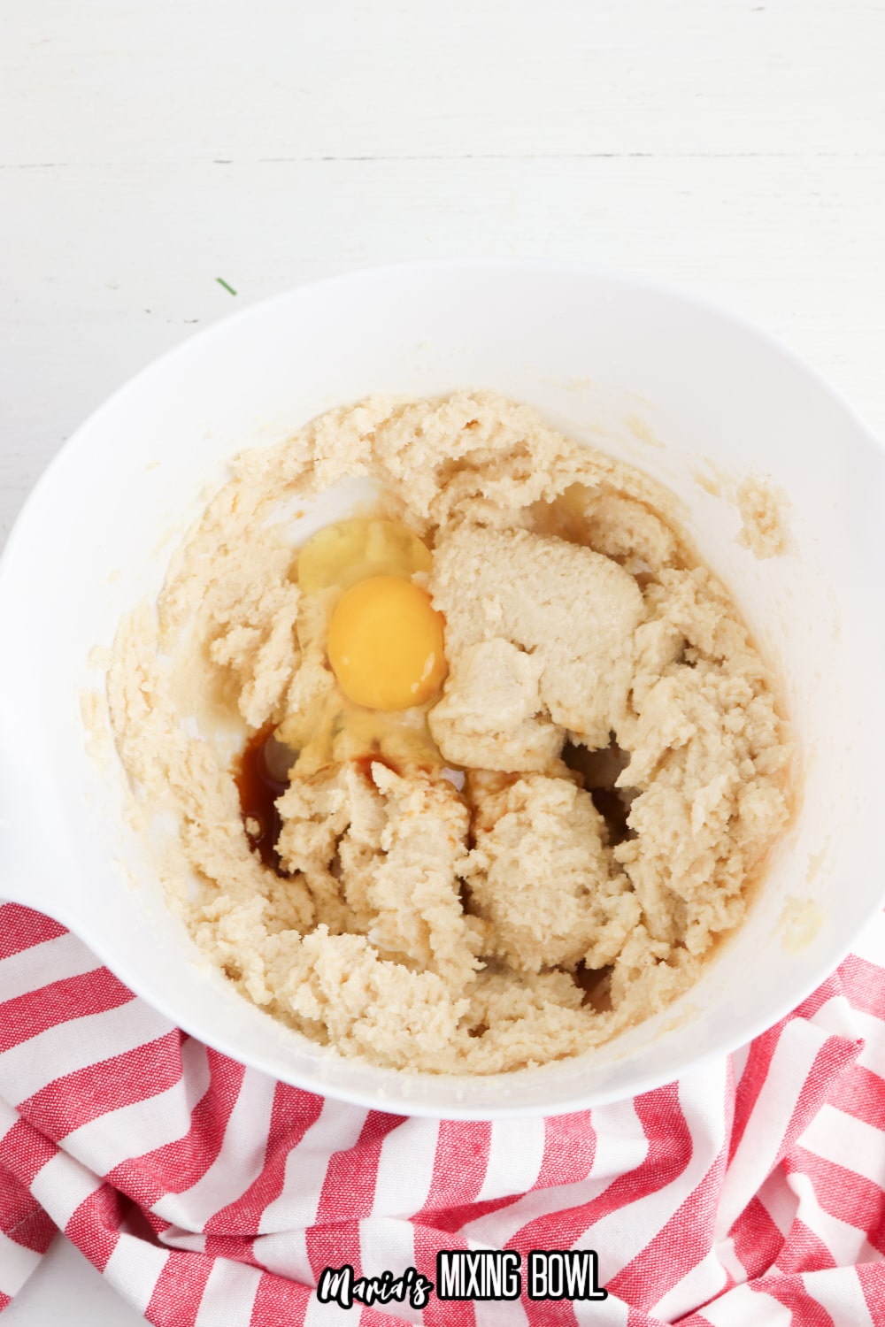 butter, sugar, eggs and vanilla in a white mixing bowl