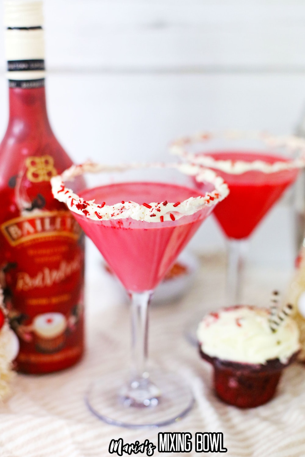 red velvet martini with a bottle of red vevlet baileys in the background