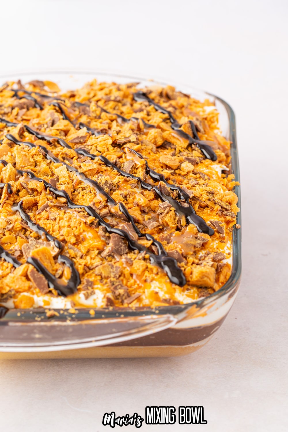 off center image of a chocolate butterfinger poke cake