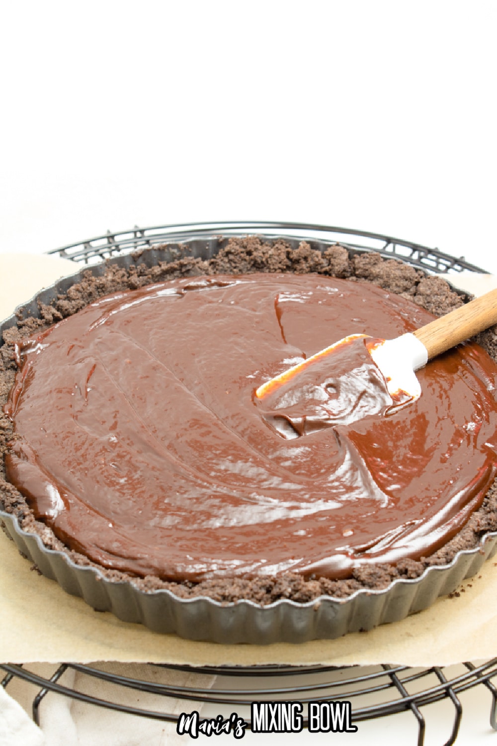 chocolate filling being poured into a cookie crust