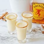 three cinnamon toast crunch shots on a marble counter top.