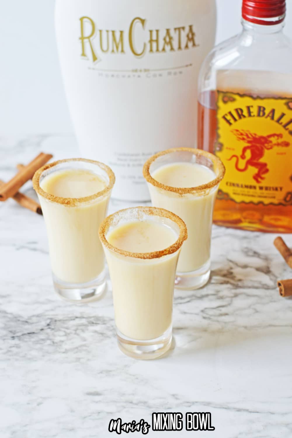 three cinnamon toast crunch shots on a marble counter top.