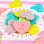 conversation heart cookies stacked on a white plate