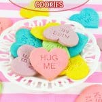 conversation heart cookies stacked on a white plate with the name in text for pinterest