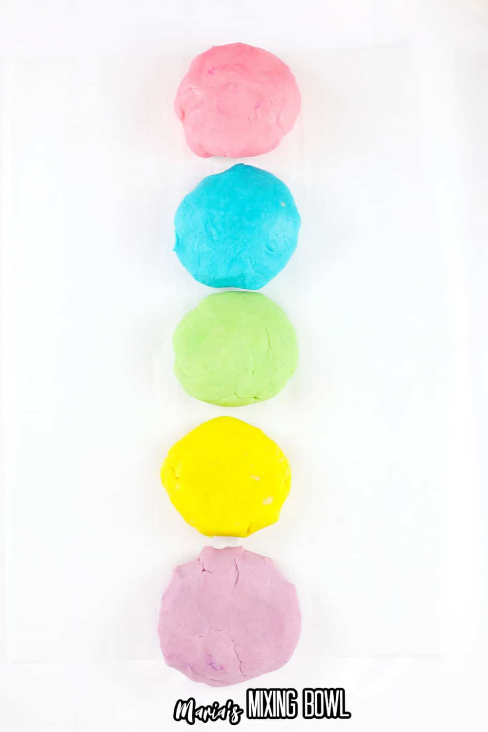 small cookie dough balls in pink, blue, green, yellow, and purple