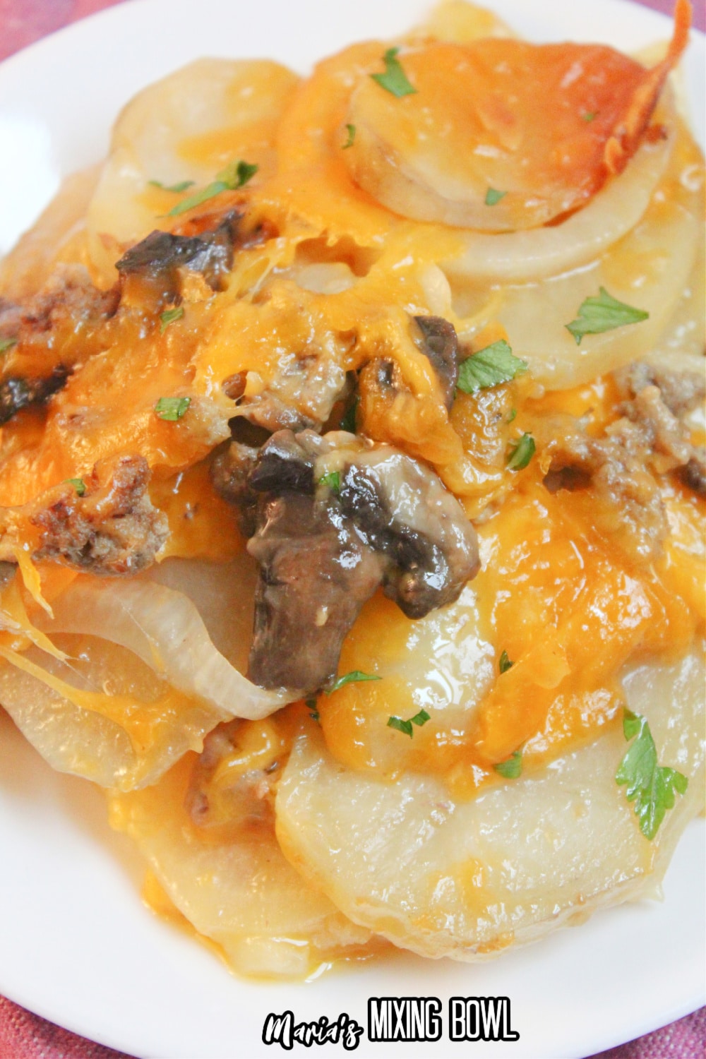 white plate of beef and potato au gratin