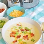 white bowl filled with crockpot loaded potato soup with bacon, green onions, and shredded cheese with the name in text for pinterest