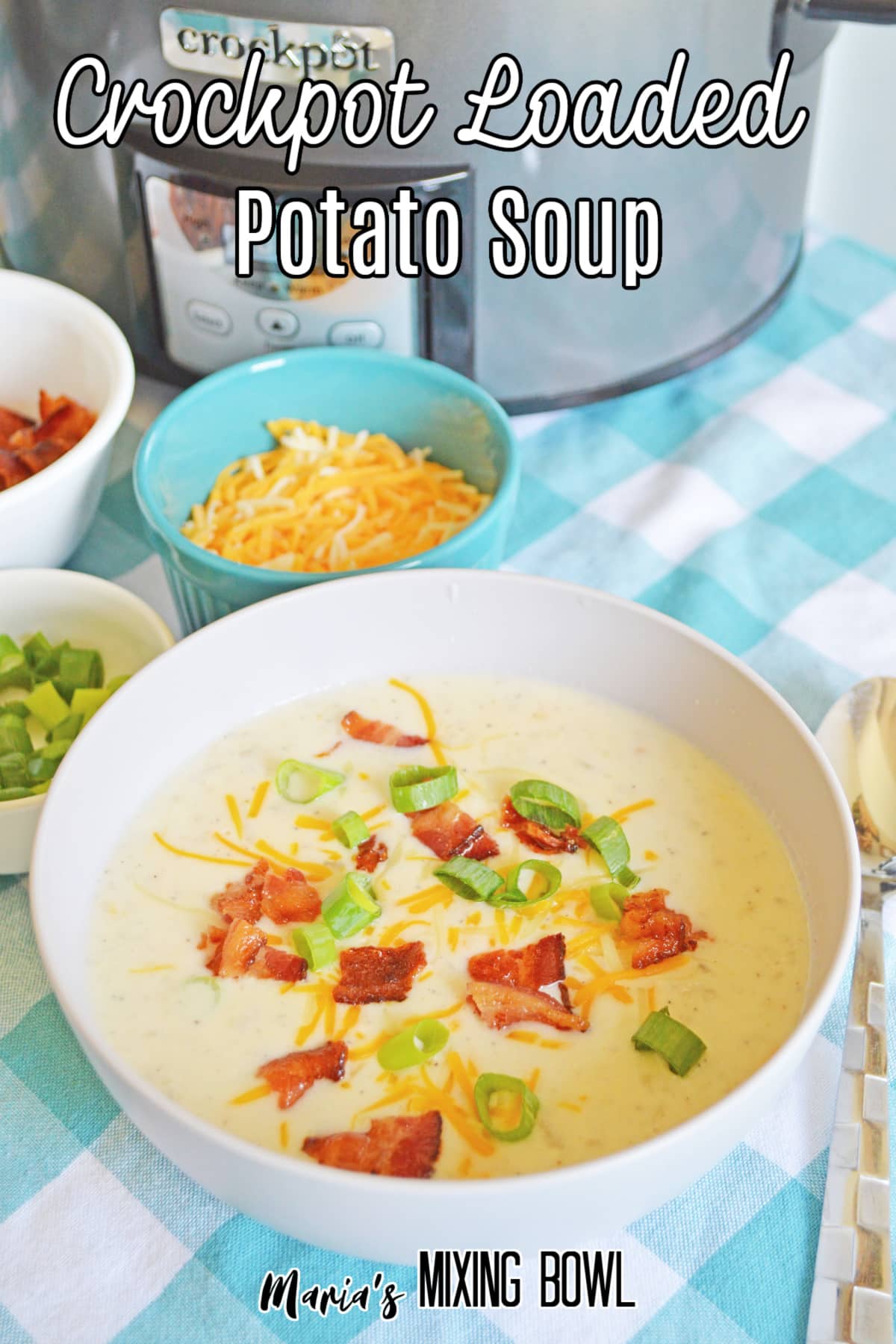 white bowl filled with crockpot loaded potato soup with bacon, green onions, and shredded cheese with the name in text for pinterest