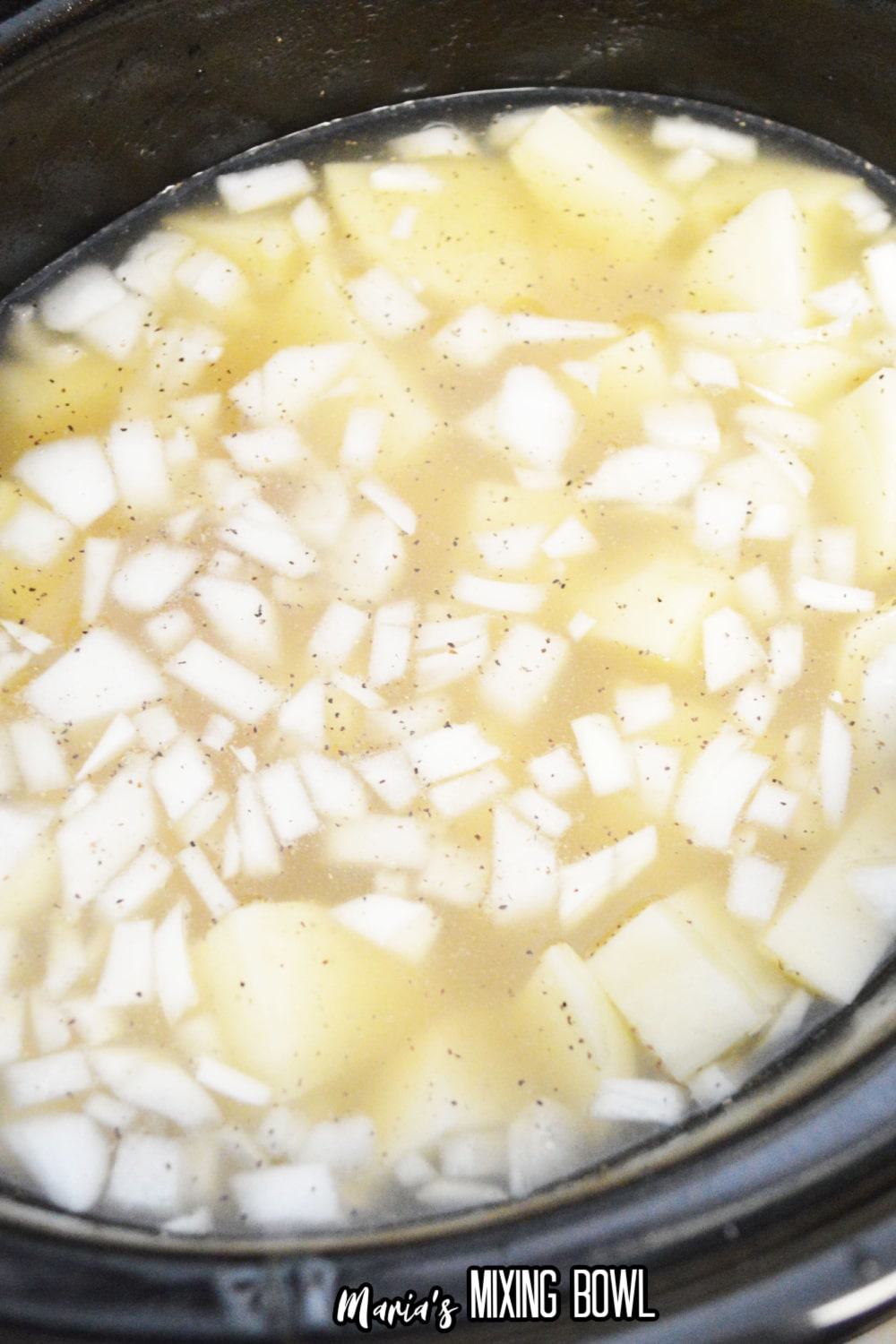potatoes, onions and chicken broth in a slow cooker.