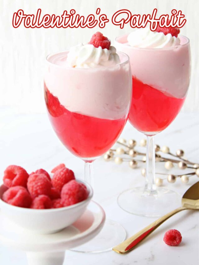 valentine's day parfait in a wine glass topped with a raspberry with the name in text for pinterest