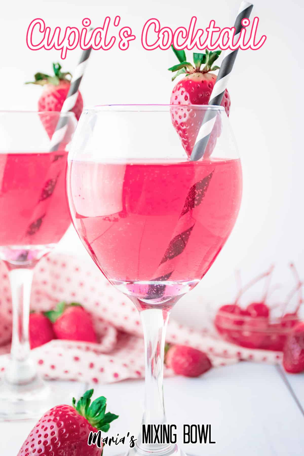 wine glass full of cupids cocktail with a strawberry on the rim with a black and white straw. with the name in text for pinterest