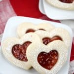 heart shaped jam cookies on a white plate