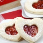 heart shaped jam cookies on a white plate with the name in text for pinterest