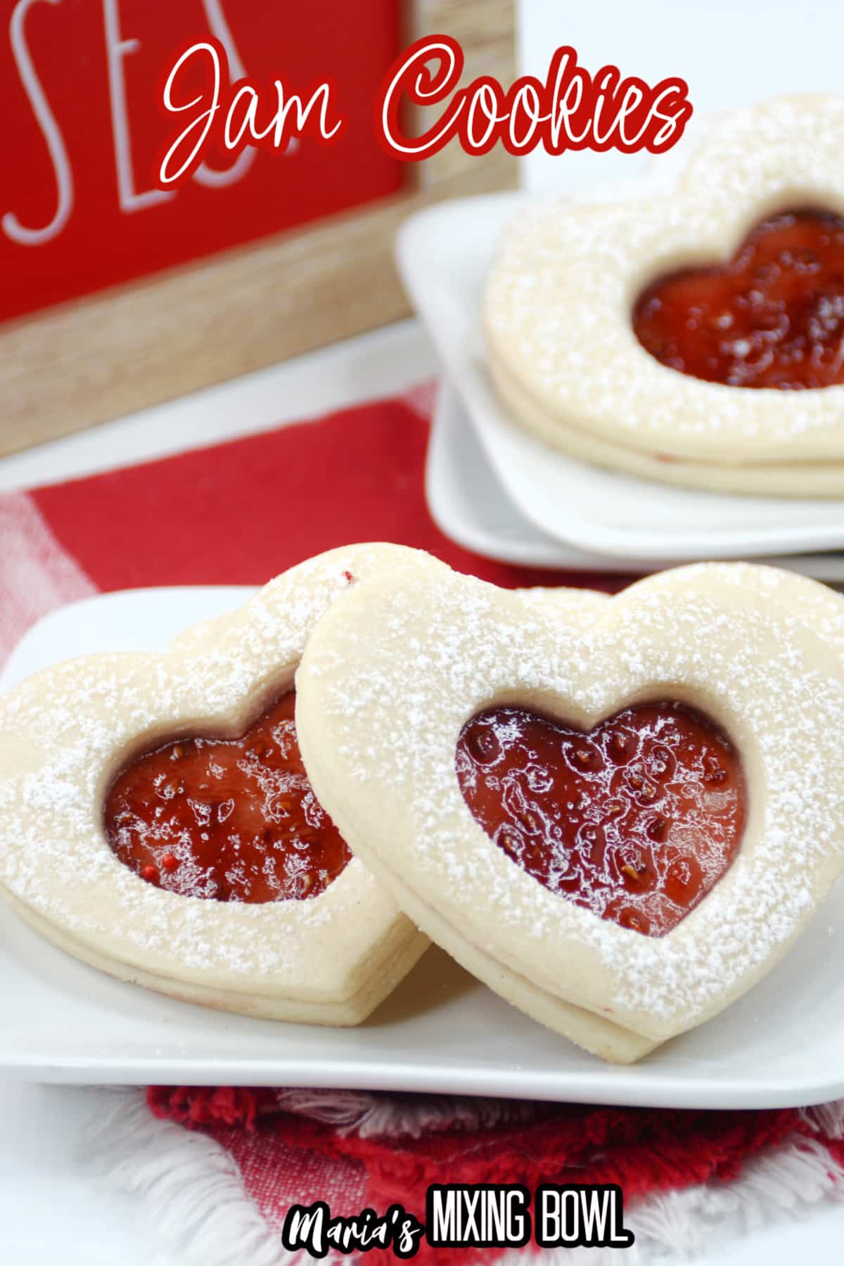 heart shaped jam cookies on a white plate with the name in text for pinterest