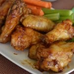 stack of maple bourbon chicken wings on a white plate