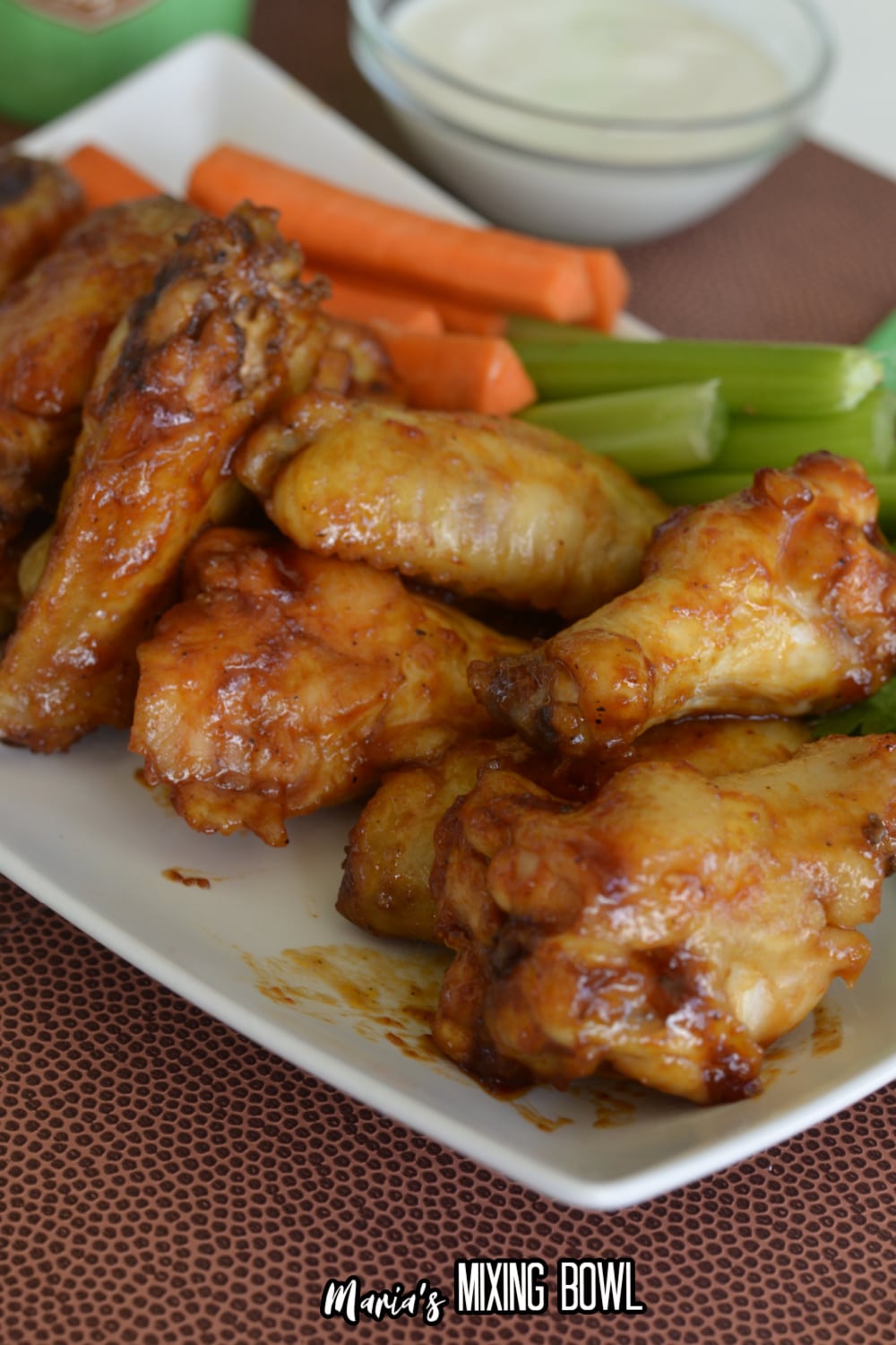 stack of maple bourbon chicken wings on a white plate