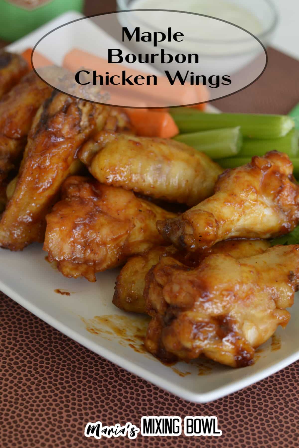 stack of maple bourbon chicken wings on a white plate with the name in text for pinterest