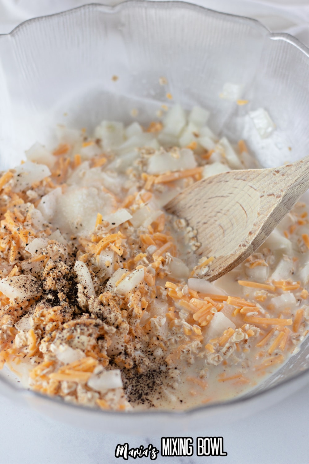 ground beef, onions, cheese, and seasonings in a large glass bowl