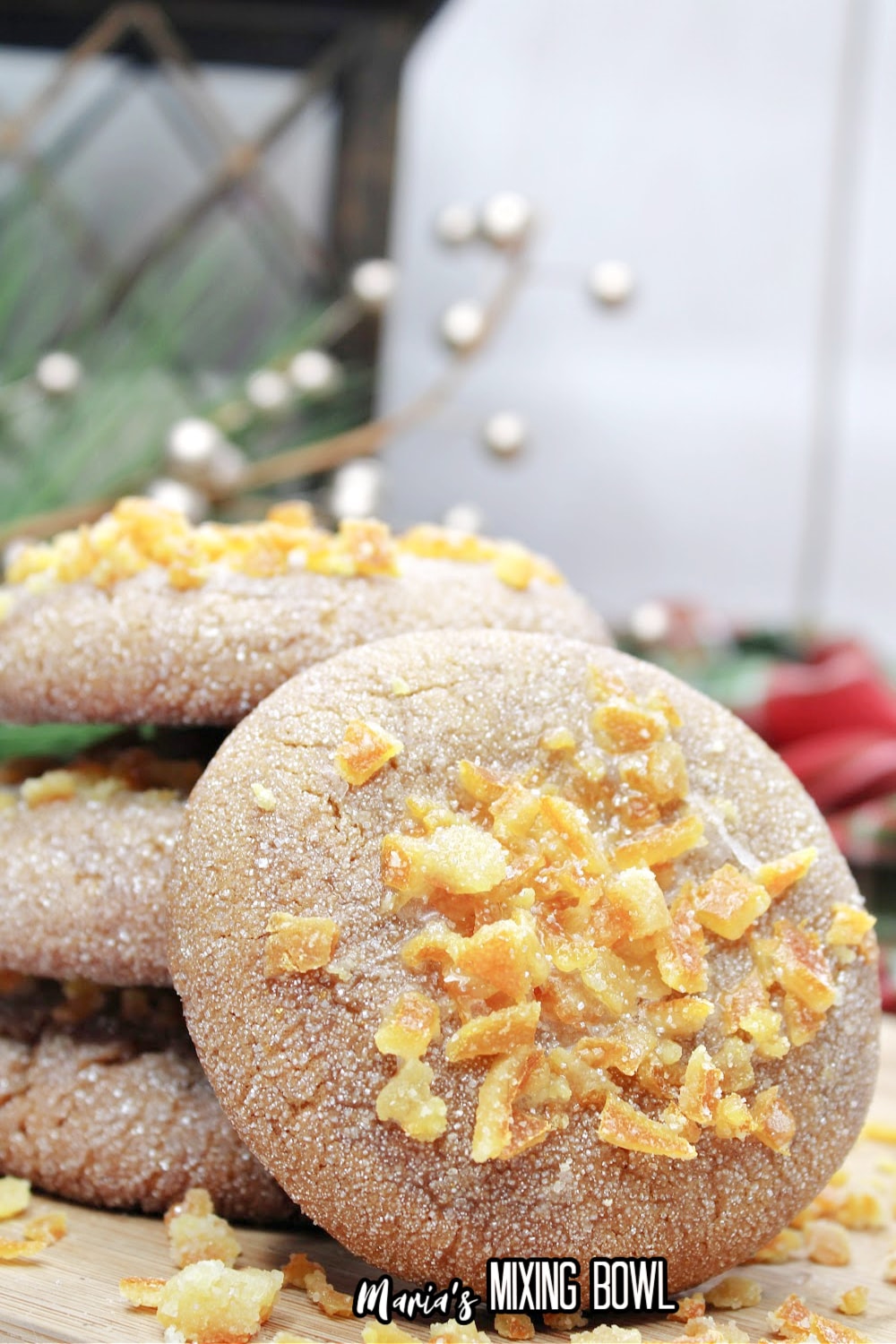 stack of orange gingerbread cookies on a wooden cutting board