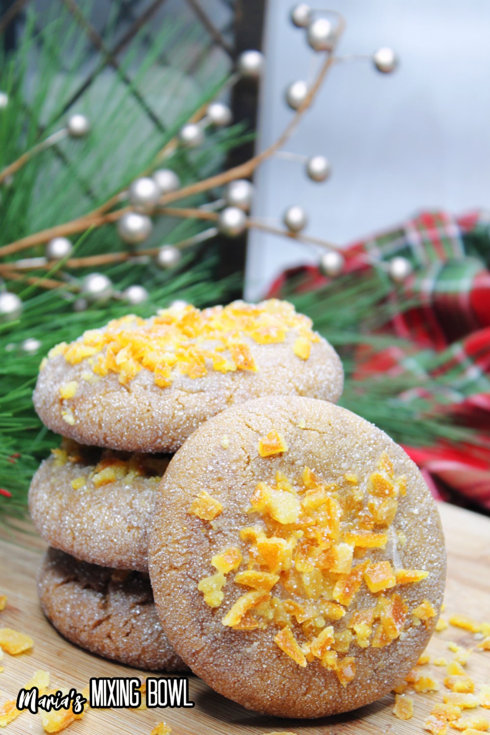 stack of orange gingerbread cookies on a wooden cutting board
