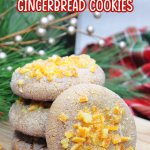 stack of orange gingerbread cookies on a wooden cutting board with the name in text for pinterest
