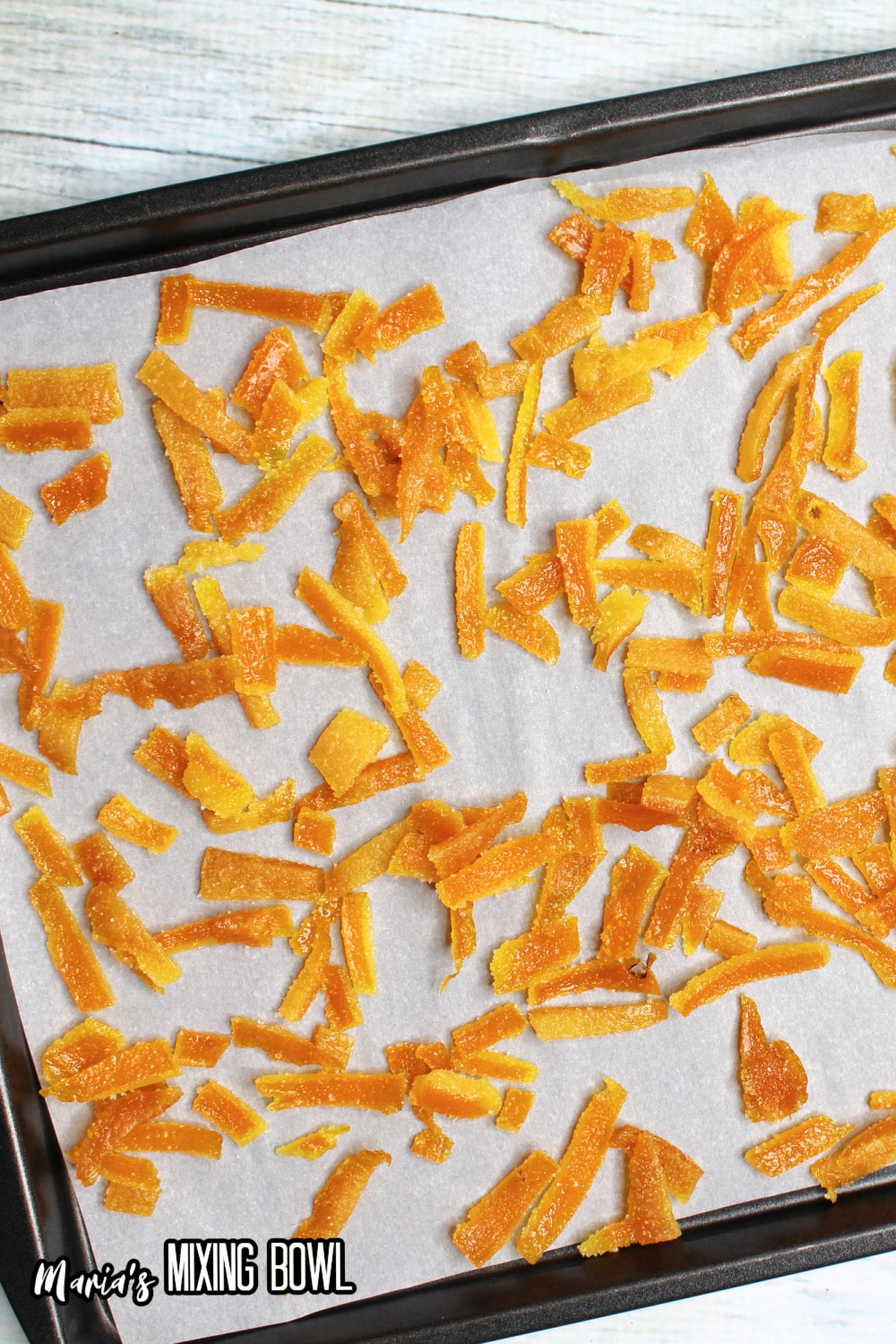 orange peels on a parchment lined baking sheet