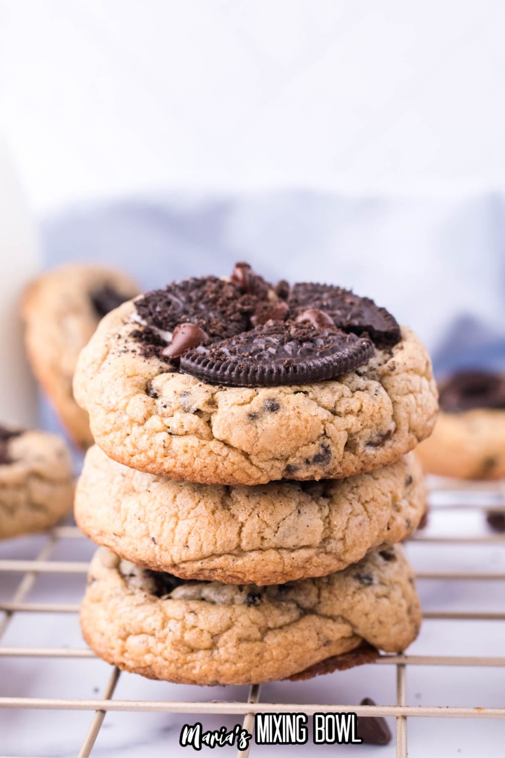 stack of three oreo chocolate chip cookies on a cooling rack