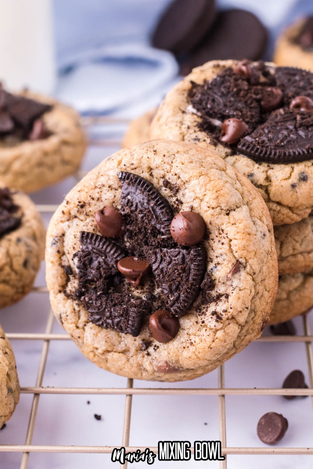 oreo chocolate chip cookie leaning against and stack of cookies