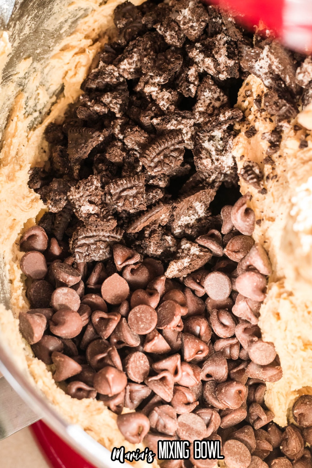oreo pieces and chocolate chips being mixed into cookie dough