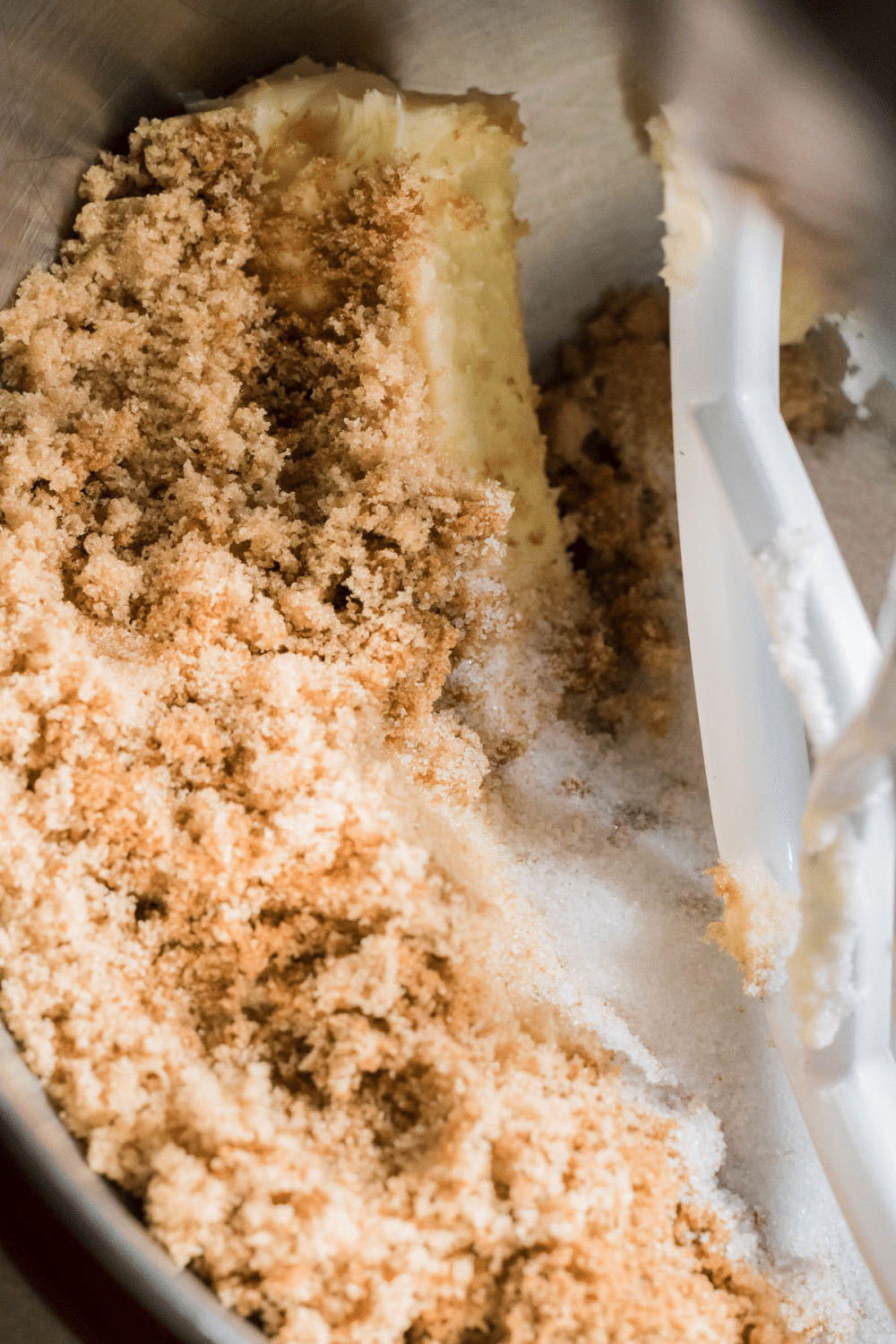 sugar and butter being creamed in a stand mixer