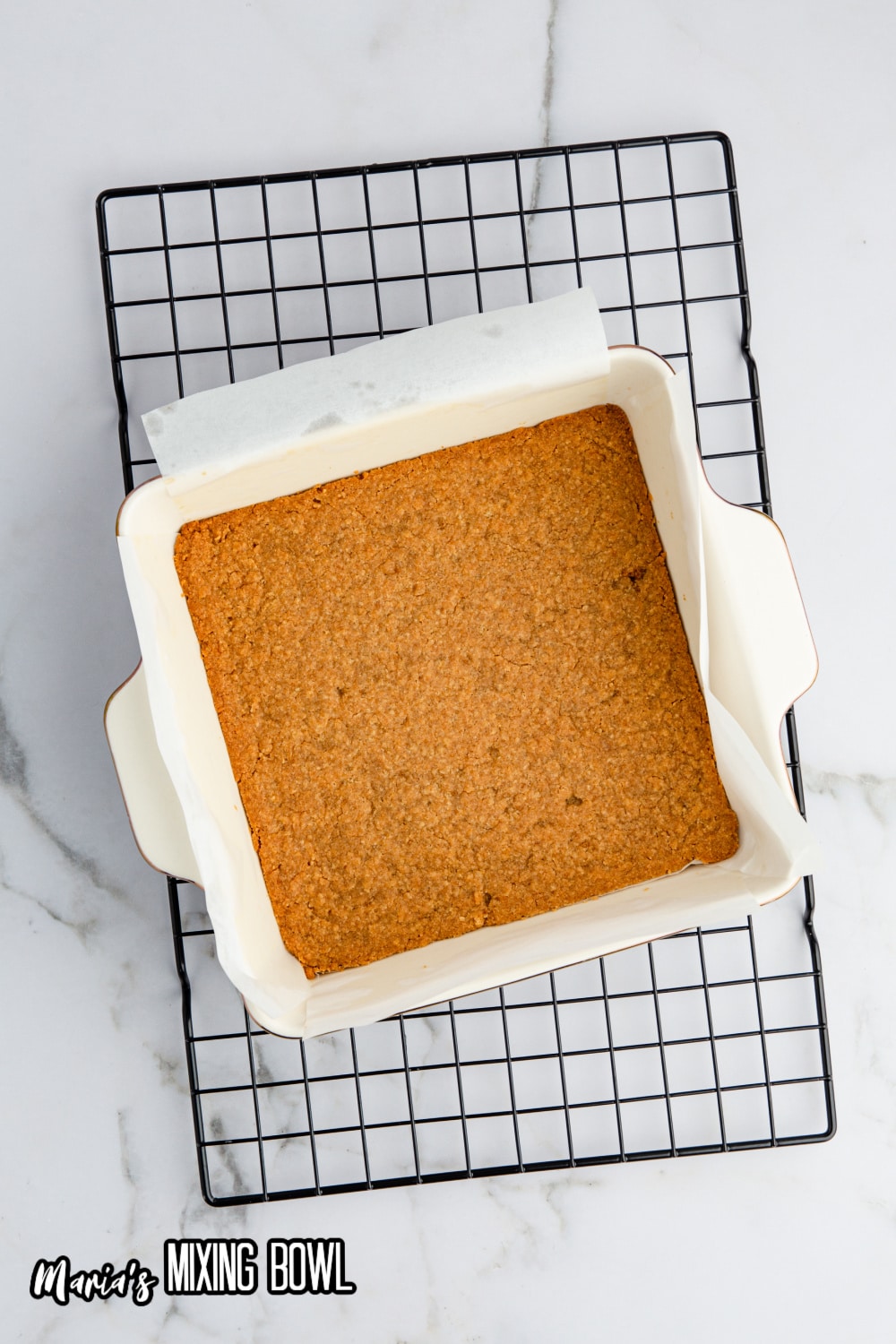 cookie crush in a white parchment lined line baking dish