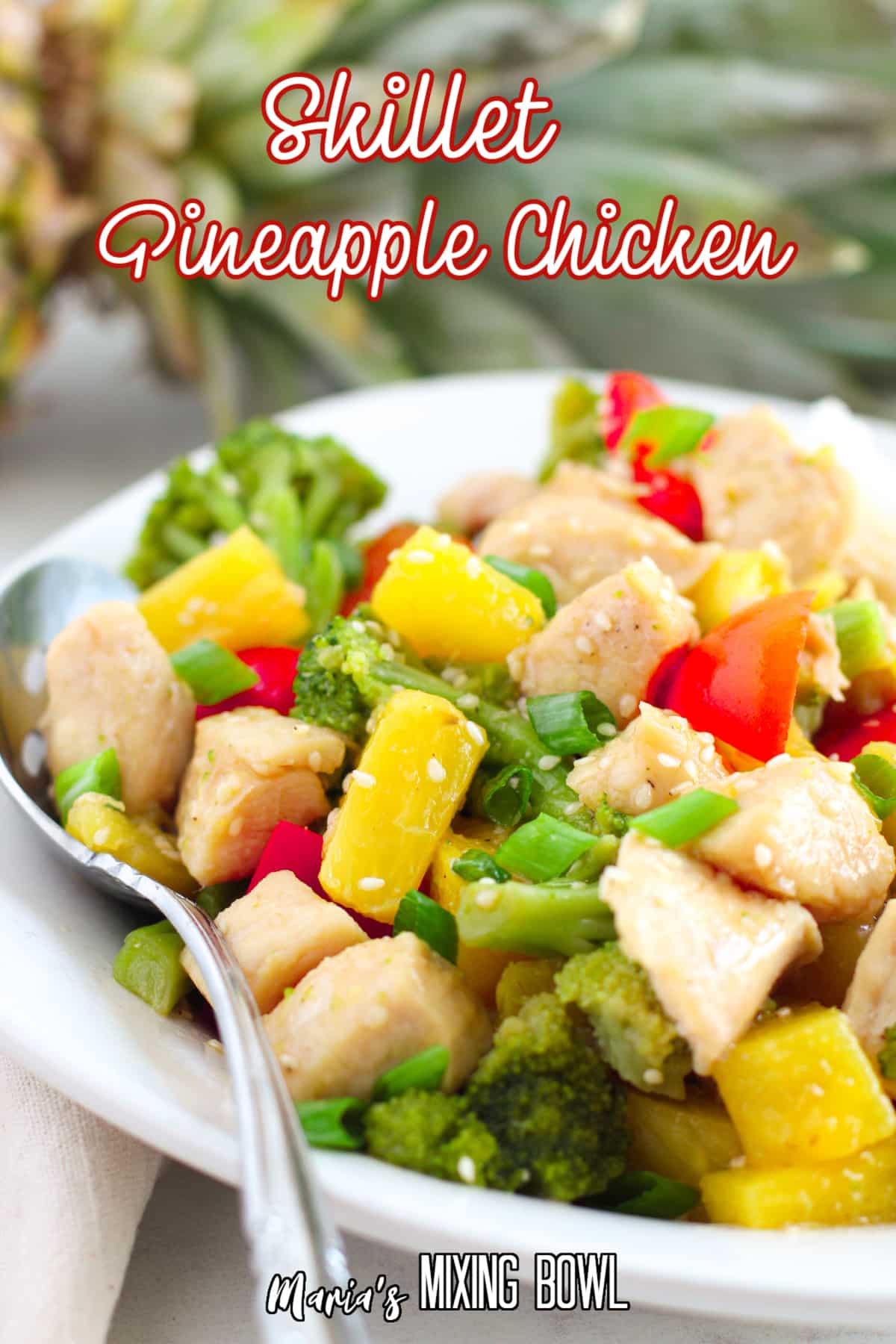 close up of pineapple chicken on a white plate with the name in text for pinterest