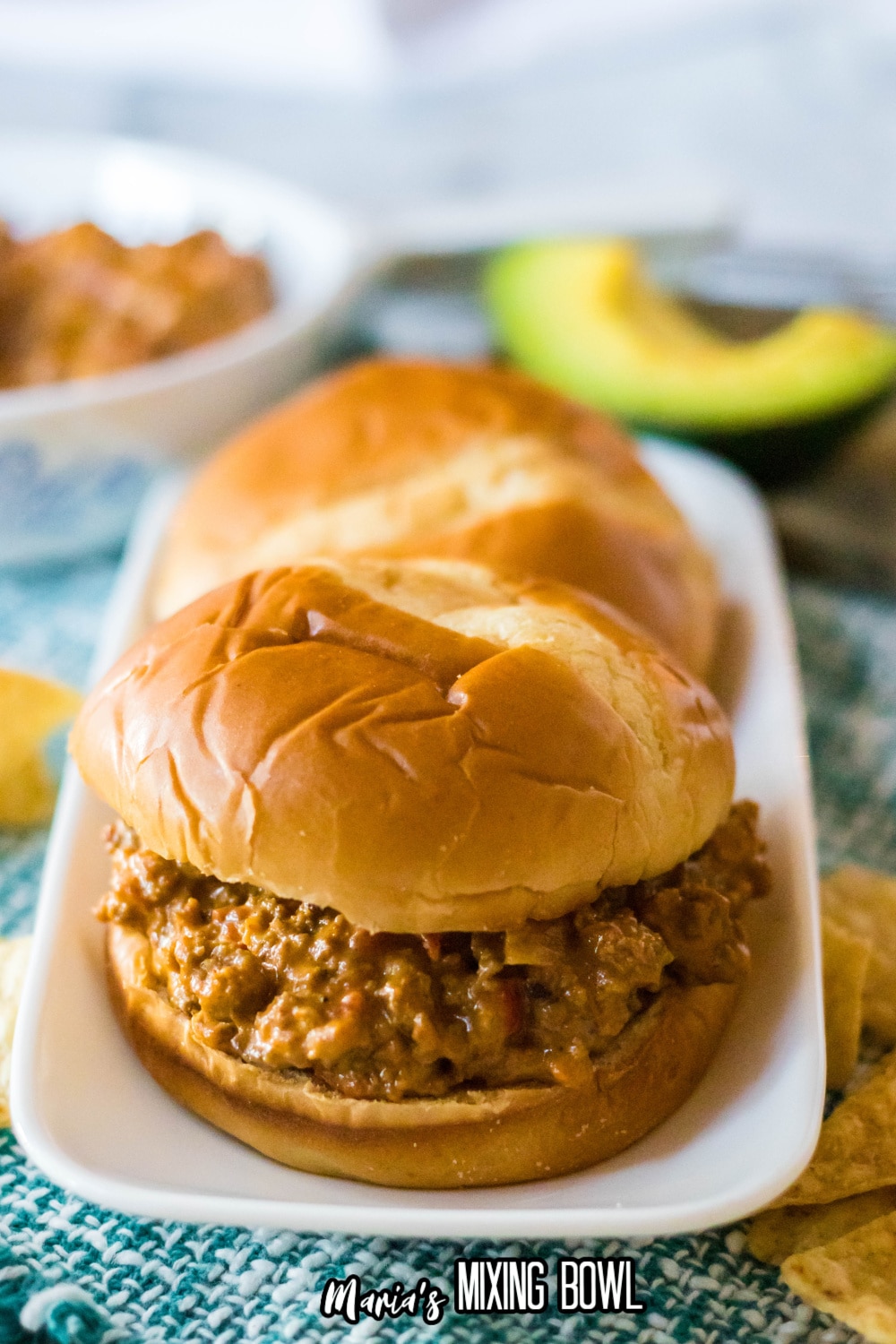 two sandwiches on a white platter