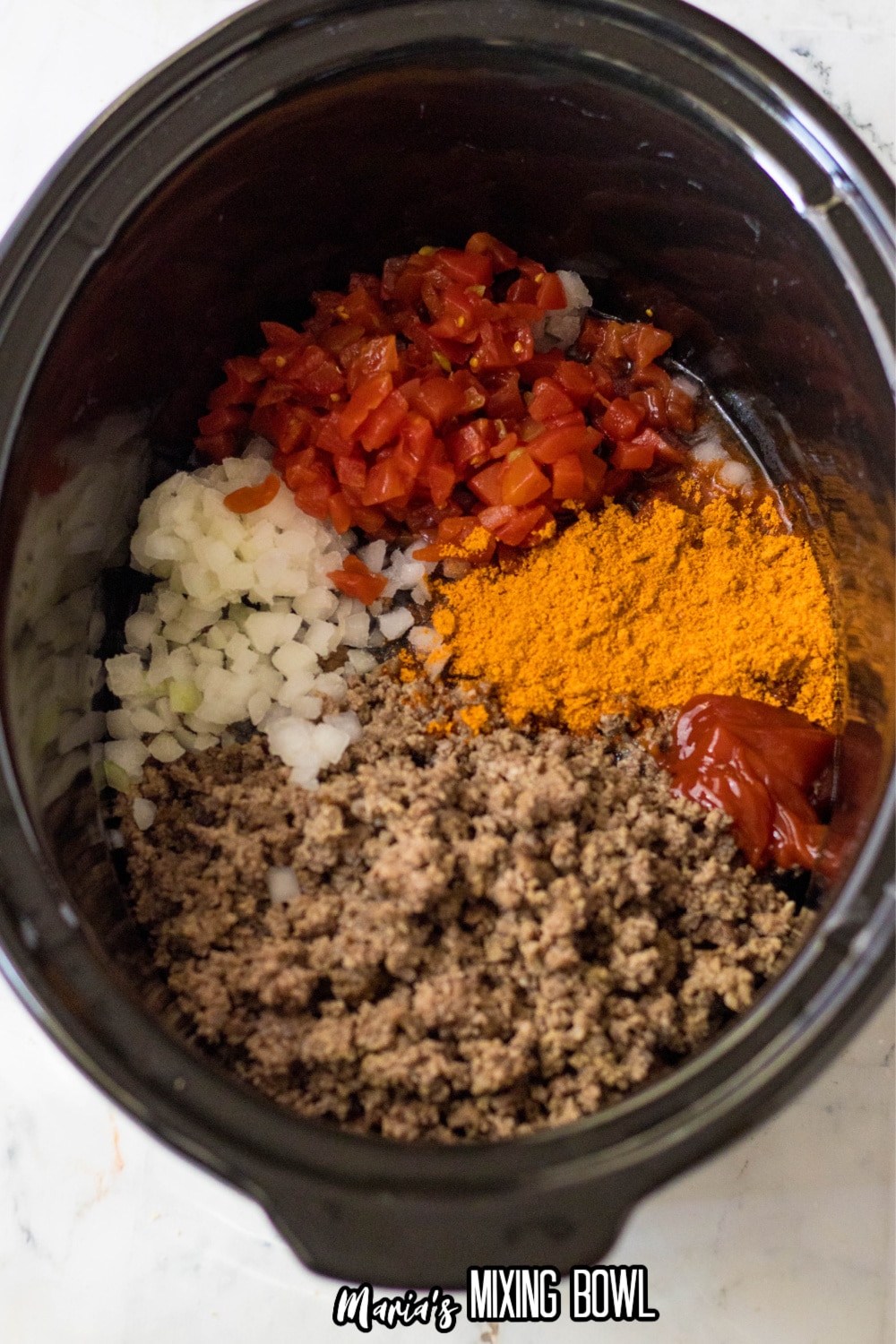 seasoning, ketchup, onions, tomatoes, and green beef in a slow cooker