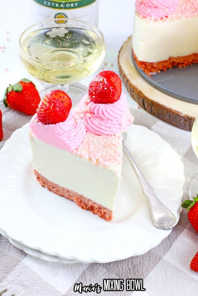 slice of strawberry champagne cheesecake on a white plate