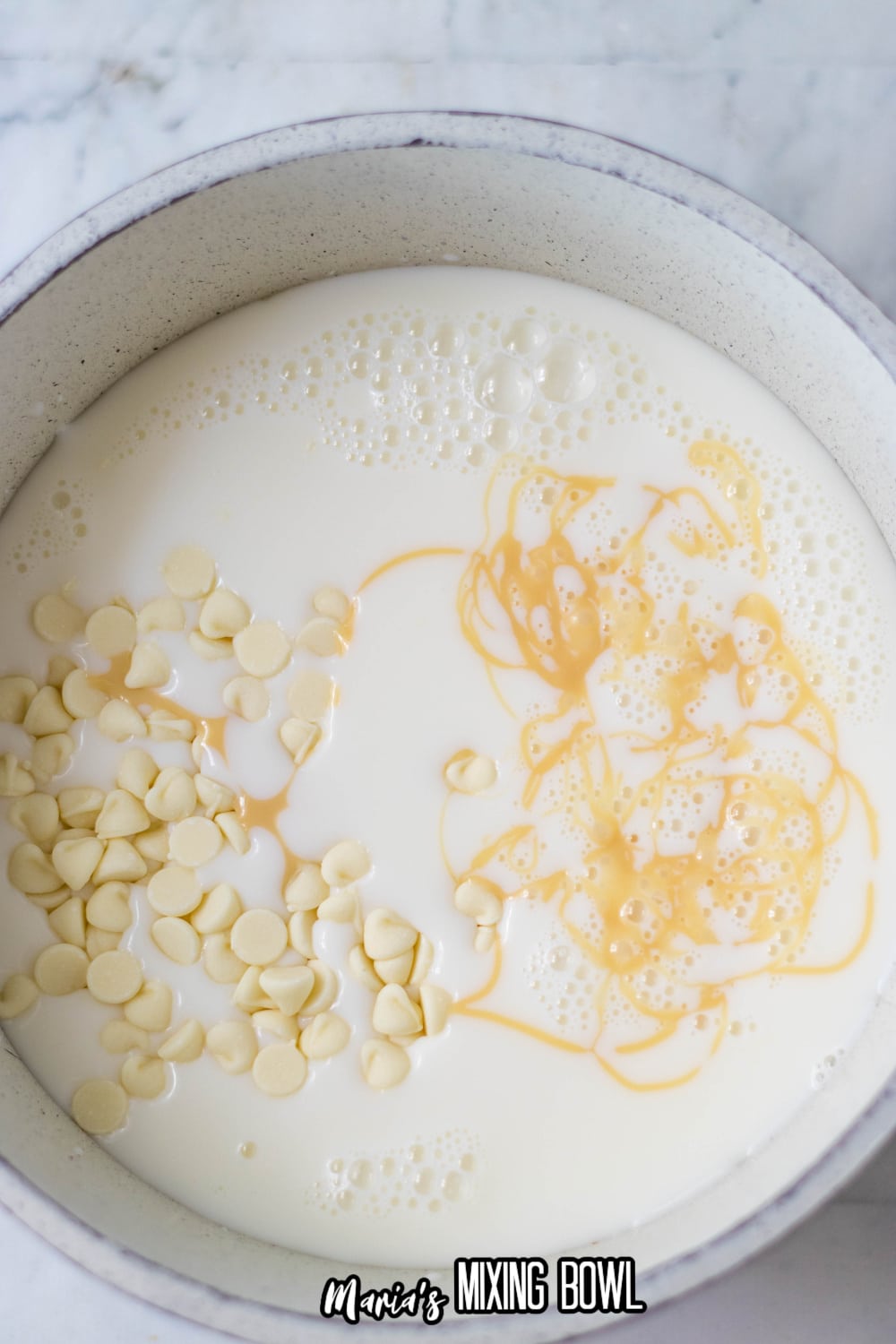 chocolate being melted in a pot of milk